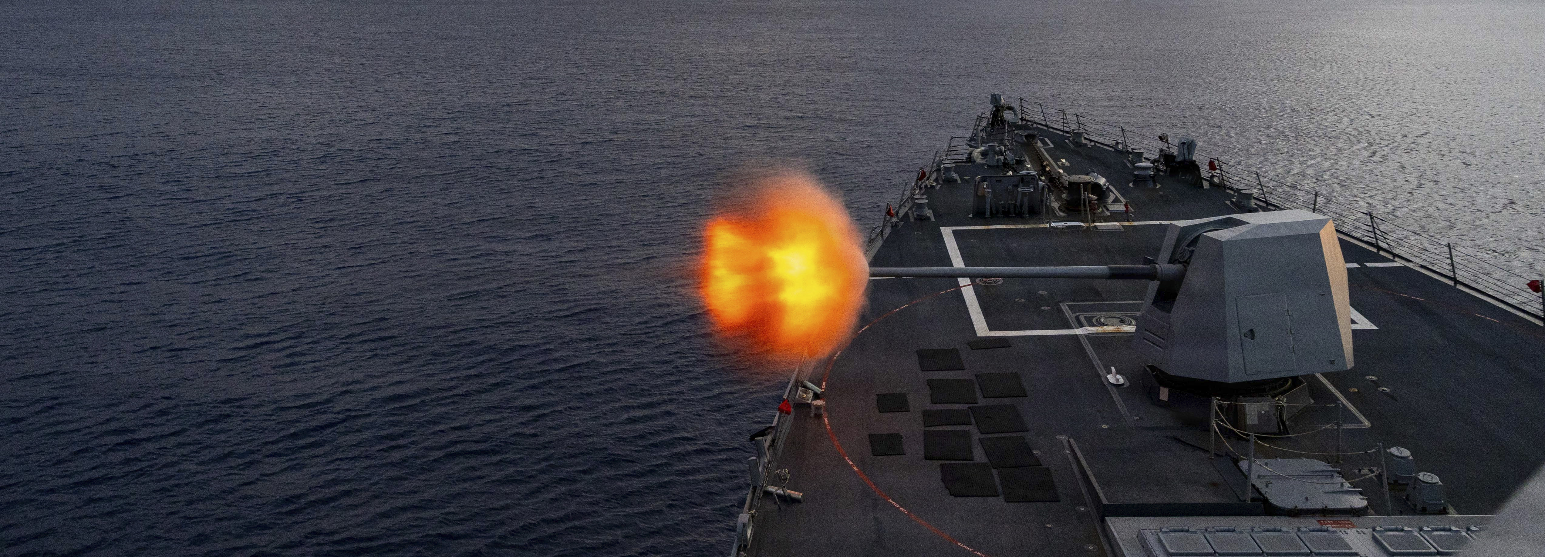 U.S. Navy Arleigh Burke-class guided-missile destroyer USS Mustin (DDG 89) fires its Mark 45 5-inch gun from the fo’c’sle at a “killer tomato” inflatable surface target during a live-fire exercise in the Indian Ocean, April 24, 2026. Mustin is forward-deployed and assigned to Destroyer Squadron (DESRON) 15, the Navy’s largest DESRON and U.S. 7th Fleet’s principal surface force. U.S. 7th Fleet, the Navy’s largest forward-deployed numbered fleet, routinely interacts and operates with allies and partners in preserving a free and open Indo-Pacific. (U.S. Navy photo by Mass Communication Specialist 2nd Class Timothy Dimal)