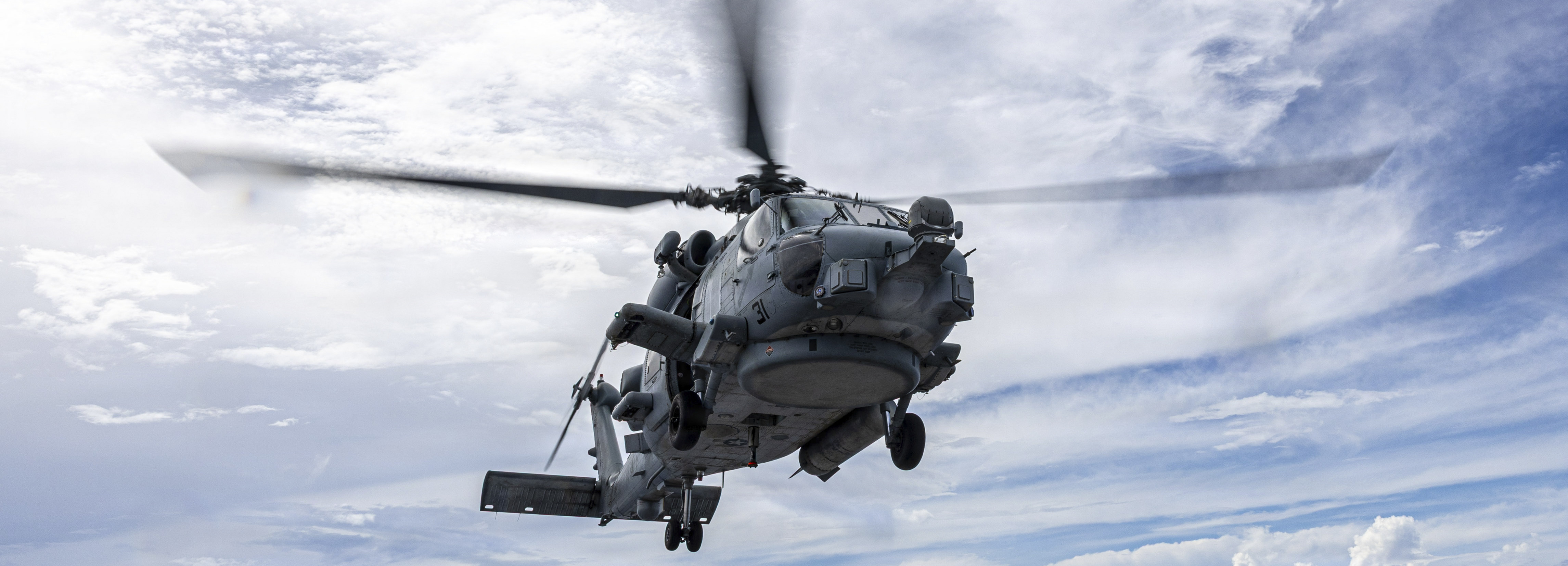 An MH-60R Sea Hawk helicopter assigned to Helicopter Maritime Strike Squadron (HSM) 35 hovers over the flight deck of Arleigh Burke-class guided-missile destroyer USS Mustin (DDG 89) while the ship is underway in the Indian Ocean, May 4, 2026. Mustin is forward-deployed and assigned to Destroyer Squadron (DESRON) 15, the Navy’s largest DESRON and U.S. 7th Fleet’s principal surface force. U.S. 7th Fleet, the Navy’s largest forward-deployed numbered fleet, routinely interacts and operates with allies and partners in preserving a free and open Indo-Pacific. (U.S. Navy photo by Mass Communication Specialist 2nd Class Timothy Dimal)