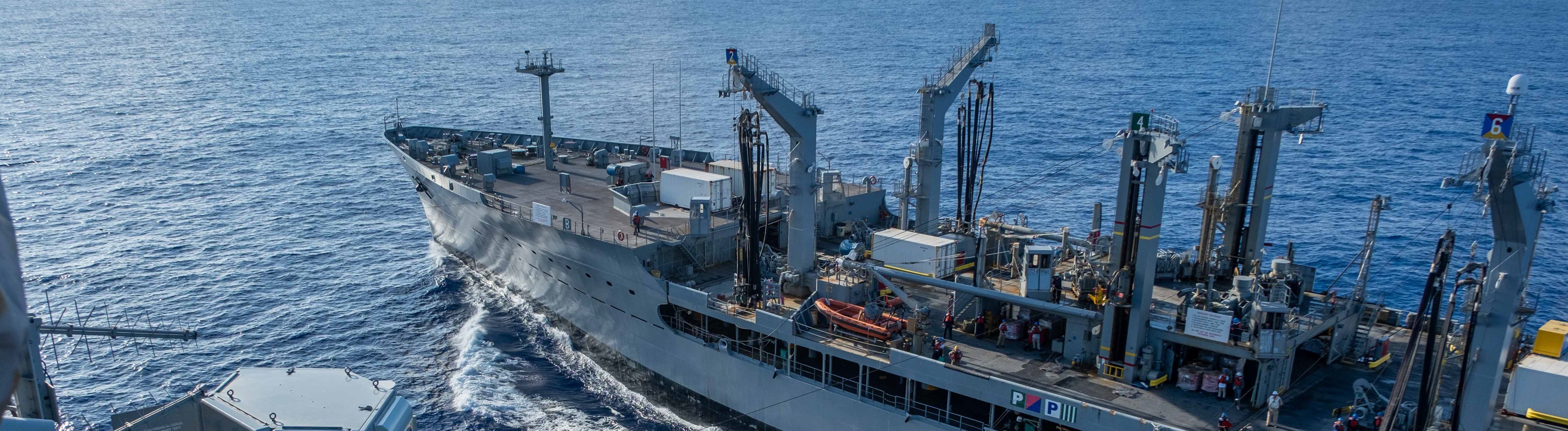 USS Ronald Reagan (CVN 76) conducts replenishment-at-sea with USNS Yukon (T-AO 202) and USNS Carl Brashear (T-AKE 7)