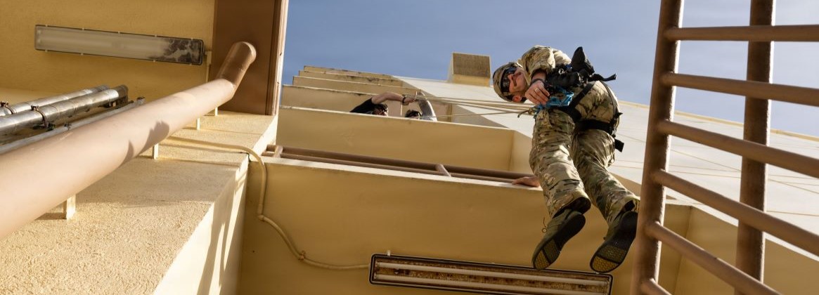 A U.S. Navy Sailor assigned to Explosive Ordnance Disposal Mobile Unit 5 (EODMU 5) repels from a multi-story building during a Rigging Ordnance Extrication Basics (ROE-B) course on Naval Base Guam, Dec. 9, 2025. The ROE-B course provides training for EOD personnel to acquire the knowledge and skills necessary to safely access ordnance in elevated complex locations through realistic scenarios. EODMU 5 is assigned to Commander, Task Force 75, which executes command and control of assigned Naval Expeditionary Combat Forces across the 7th Fleet area of operations to defend U.S. and allied and partner interest. (U.S. Navy photo by Natasha Ninete)