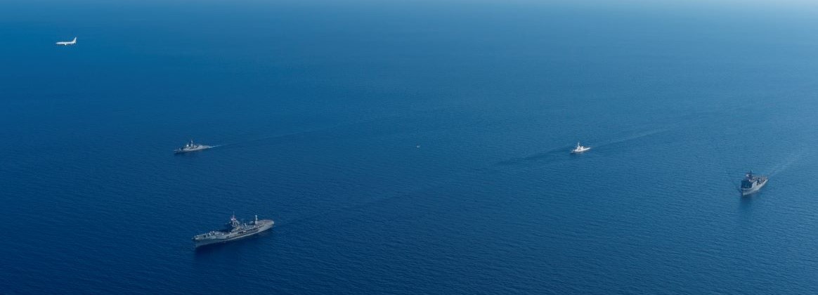 From left: a U.S. Navy P-8A Poseidon assigned to Patrol Squadron (VP) 47, Royal Australian Navy Anzac-class frigate HMAS Toowoomba (FFH 156), U.S. 7th Fleet flagship USS Blue Ridge (LCC 19), an MH-60R Seahawk helicopter assigned to HMAS Toowoomba, Philippine Coast Guard Teresa Magbanua-class patrol vessel BRP Melchora Aquino (MRRV-9702), and U.S. Navy Whidbey Island-class dock landing ship USS Ashland (LSD 48) conduct a group sail during a multilateral exercise with the Armed Forces of the Philippines and Royal Australian Navy in the Sulu Sea, April 13, 2026.