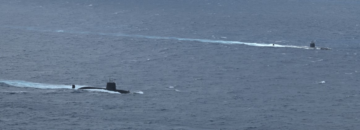The Los Angeles-class fast-attack submarine USS Santa Fe (SSN 763) and a Japan Maritime Self-Defense Force (JMSDF) submarine steam alongside one another during Submarine Exercise (SUBEX) 25-1 in the P