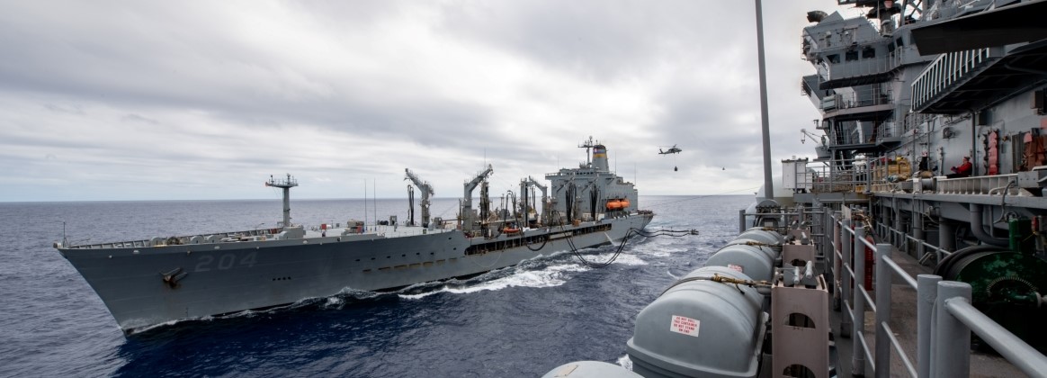 The forward-deployed amphibious assault ship USS America (LHA 6), flagship of the America Strike Group, conducts a replenishment-at-sea with the U.S. Military Sealift Command Henry J. Kaiser-class fle