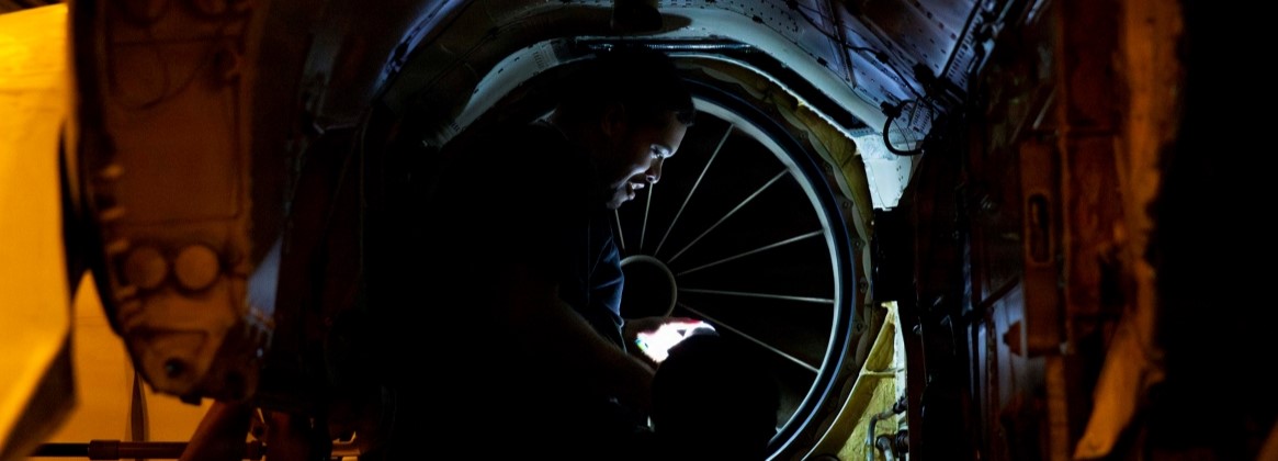 U.S. Navy Aviation Structural Mechanic (Equipment) 2nd Class Puluo Tua conducts maintenance on an F/A-18E Super Hornet, attached to Strike Fighter Squadron (VFA) 14, in the hangar bay of Nimitz-class aircraft carrier USS Abraham Lincoln (CVN 72) on Jan. 9, 2026. The Abraham Lincoln Carrier Strike Group is underway conducting routine operations in the U.S. 7th Fleet area of operations. Units assigned to 7th Fleet conduct regular Indo-Pacific patrols to deter aggression, strengthen alliances and partnerships, and advance peace through strength. (U.S. Navy photo by Mass Communication Specialist 3rd Class Shepard Fosdyke-Jackson)